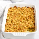 Rotisserie Chicken and Stuffing Casserole served in a baking dish with golden stuffing topping and fresh herbs.