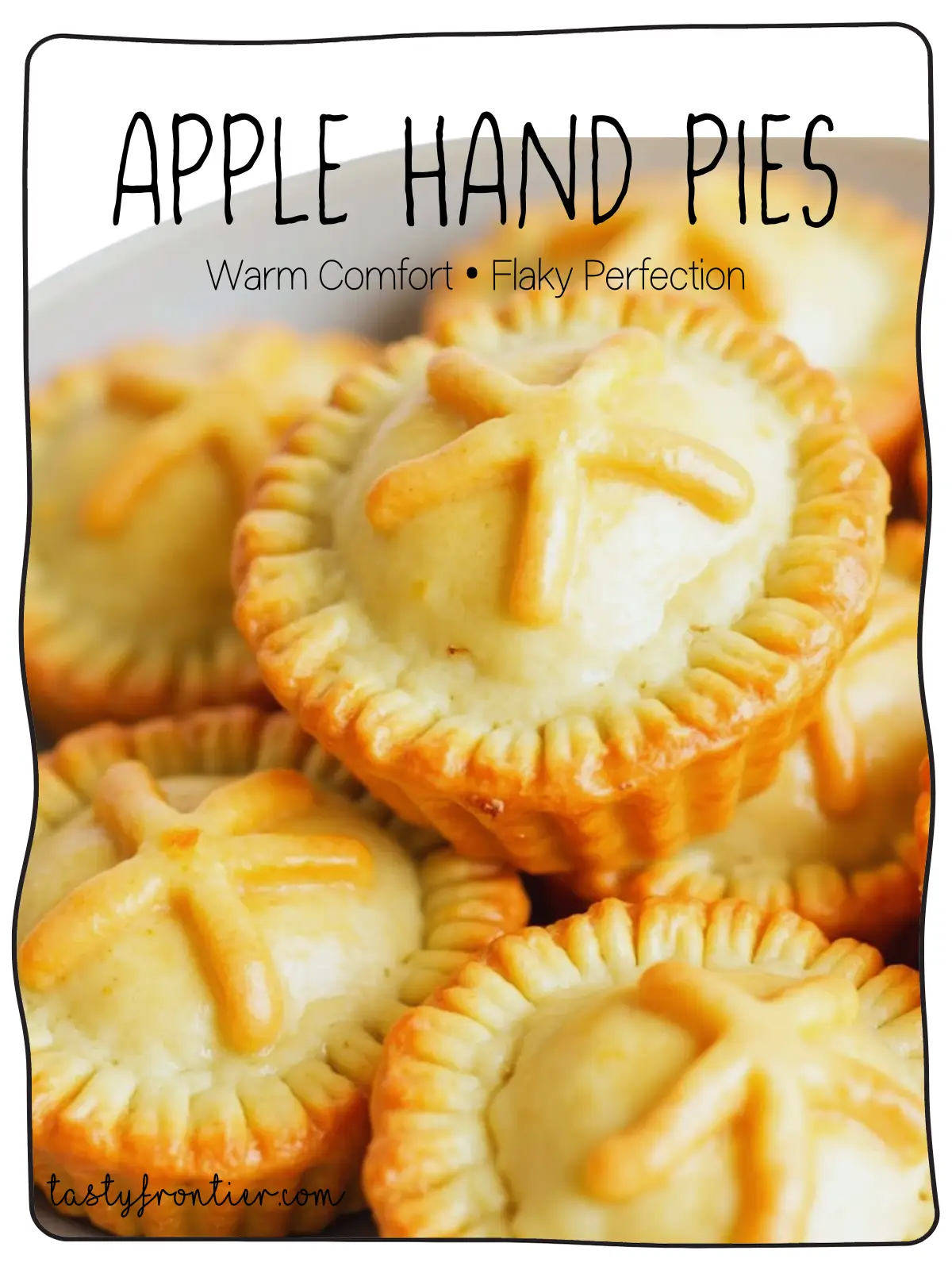 Golden-brown apple hand pies with flaky crust and warm cinnamon-apple filling on a white background.