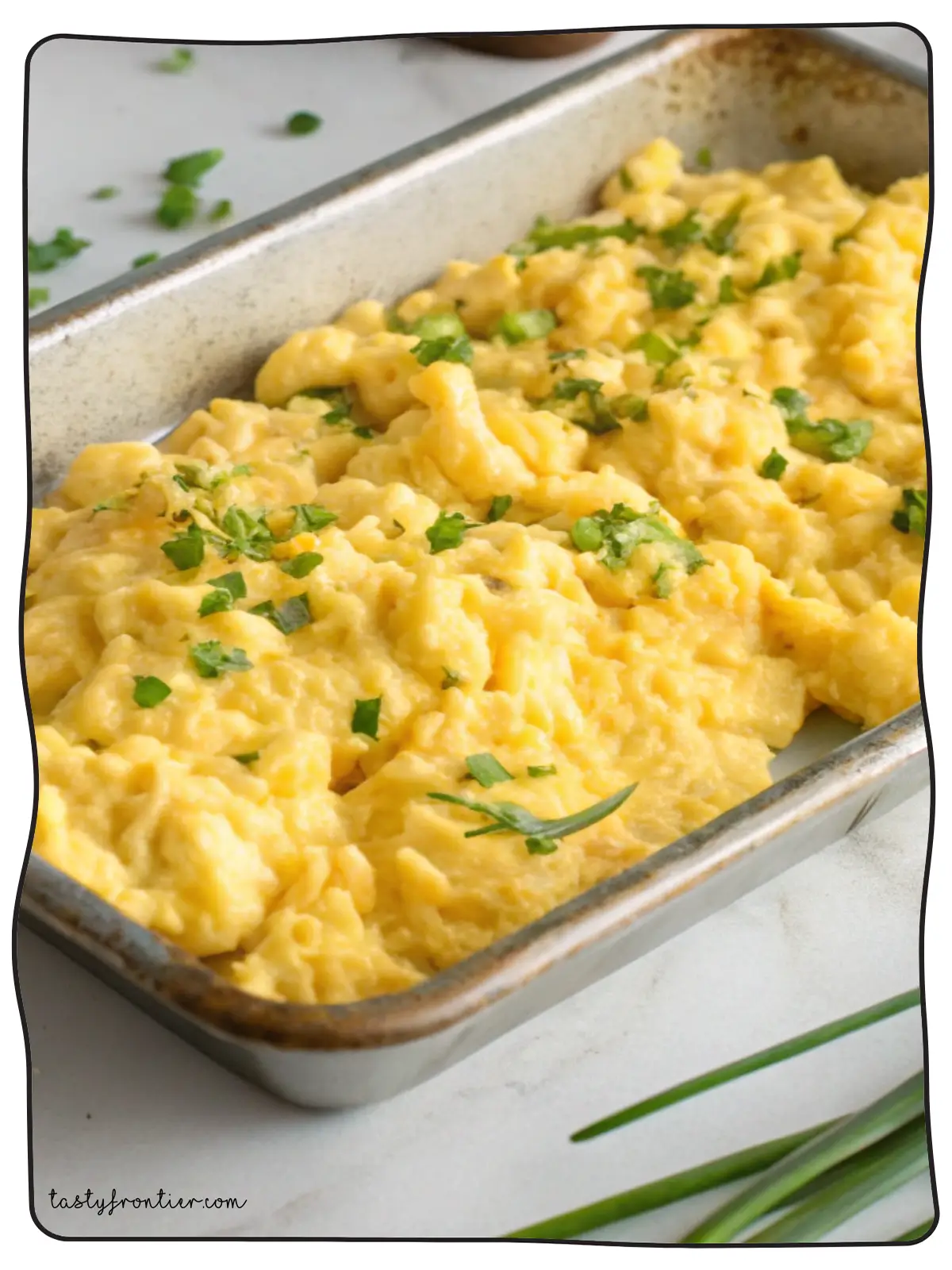 Fluffy oven-baked scrambled eggs on a white marble countertop